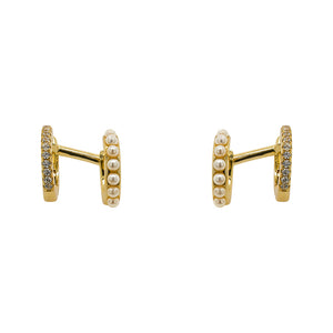 
                  
                    Load image into Gallery viewer, One pair of 14 kt yellow gold vermeil double ear hugger ear cuffs. Adorned with pearls on one side and crystals on the other. Displayed front facing on a marble background.
                  
                