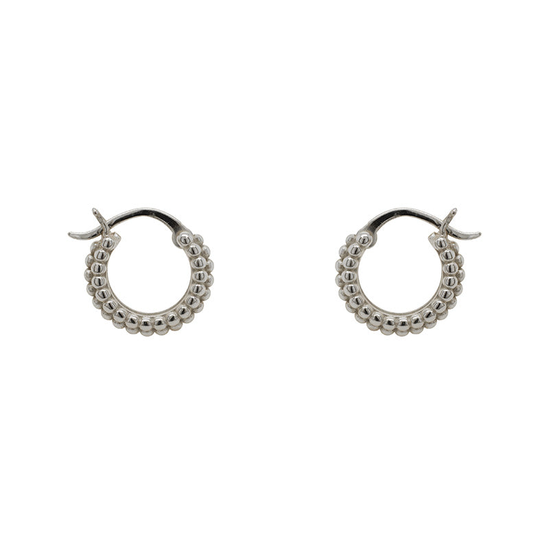 Small, beaded hoop earrings with a hinged post closure made of 925 sterling silver. Displayed side facing on a white background.