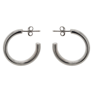 
                  
                    Load image into Gallery viewer, These modern, thick hoop earrings are made of solid sterling silver. The 26 mm hoops are displayed side facing on a marbled background.
                  
                