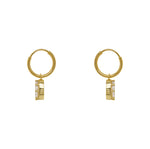 Hoop style earrings made of 14 kt yellow gold vermeil with dangling pear cut crystals each secured with 8 prongs. Displayed side facing on a white background.