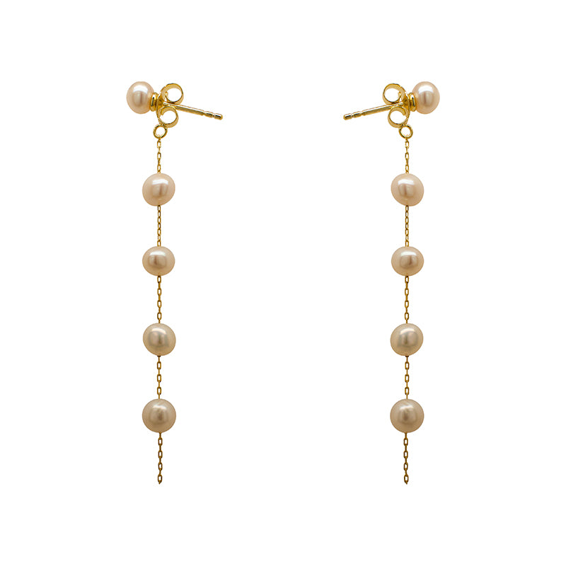 These pearl earrings are made of 925 sterling silver with 14 kt yellow gold vermeil. The earrings drop 65 mm from top to bottom. Displayed side facing on a marble background.