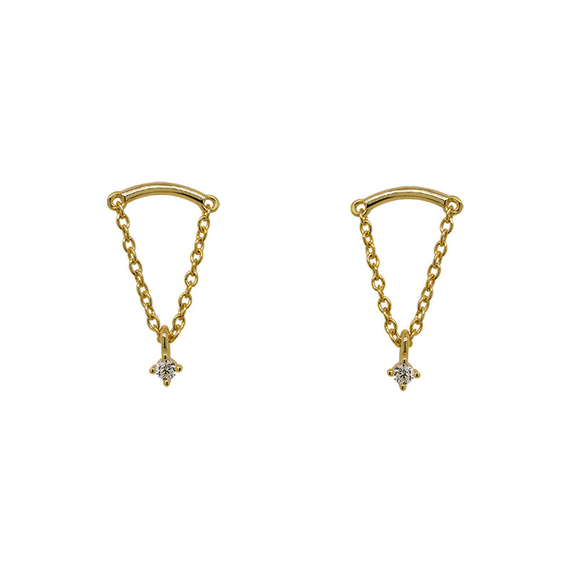 A pair of arch shaped studs with chain and a dangling crystal. Made of 14 kt yellow gold vermeil.