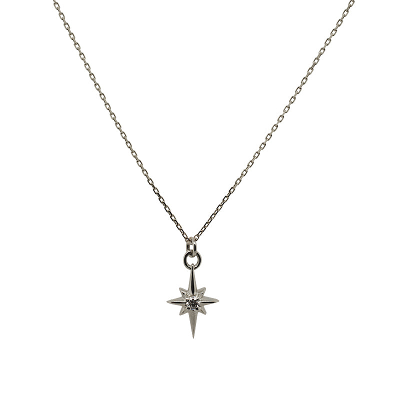 Petite size north star charm necklace with a tiny diamond in the center made of solid 14 kt white gold.