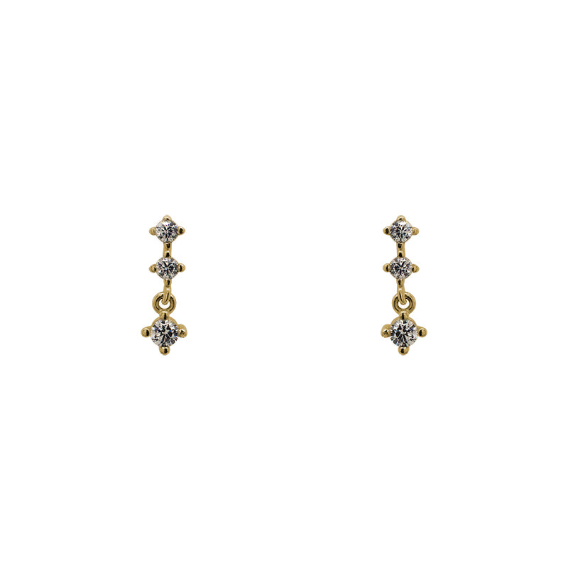 A pair of north south set double crystal studs with an additional stud dangling from the bottom, and made of 14 kt yellow gold vermeil.