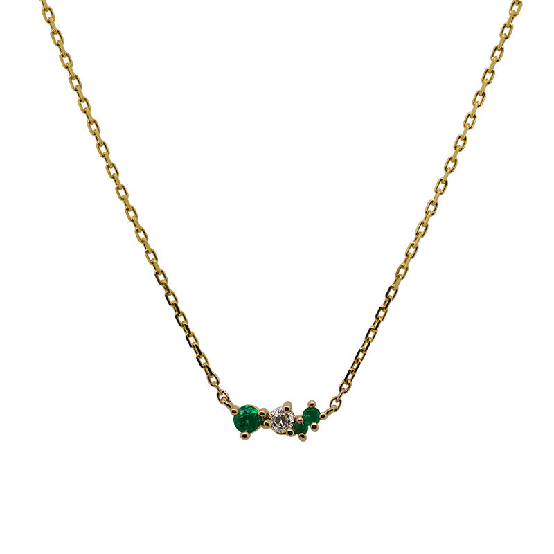
                  
                    Load image into Gallery viewer, Front view of an asymmetrical cluster necklace set with three round emeralds and one round diamond. Set in 14 kt yellow gold
                  
                