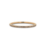 Front view of a micro pavé diamond eternity band cast in 14 kt yellow gold from King + Curated.
