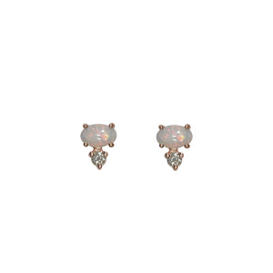 
                  
                    Load image into Gallery viewer, Front view of white oval opals, set east-west in 14 kt rose gold with 1 round accent diamond set vertically below each. Displayed on white background.
                  
                
