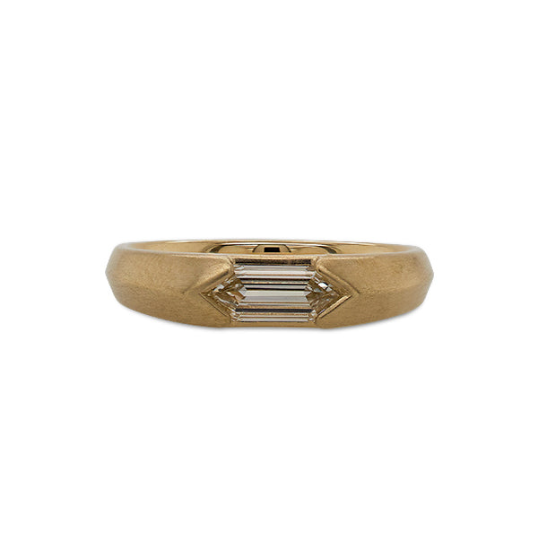Front view of a knife edge solitaire ring with an elongated, hexagon cut diamond cast in 14 kt yellow gold with a matte finish.
