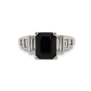 
                  
                    Load image into Gallery viewer, Front view of emerald cut black sapphire ring with 6 baguette cut diamonds set in 14 kt white gold.
                  
                