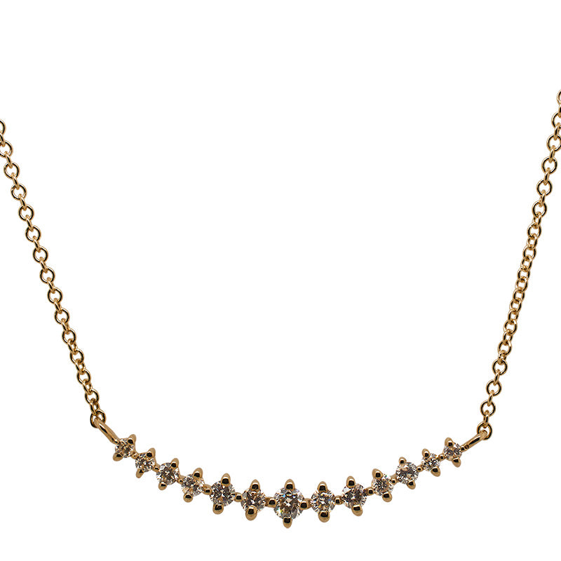 Front view of a 13 stone graduated diamond pendant necklace cast in 14 kt yellow gold.