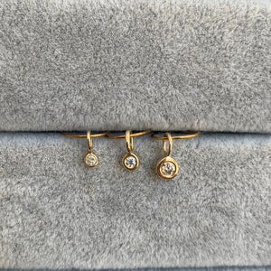 
                  
                    Load image into Gallery viewer, closeup of 3 bezel set diamond charms, in small, medium and large sizes, each set in 14k yellow gold with oversized bails.
                  
                
