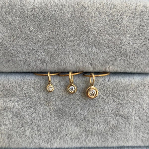 
                  
                    Load image into Gallery viewer, closeup of 3 bezel set diamond charms, in small, medium and large sizes, each set in 14k yellow gold with oversized bails.
                  
                