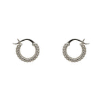Small, beaded hoop earrings with a hinged post closure made of 925 sterling silver. Displayed side facing on a white background.