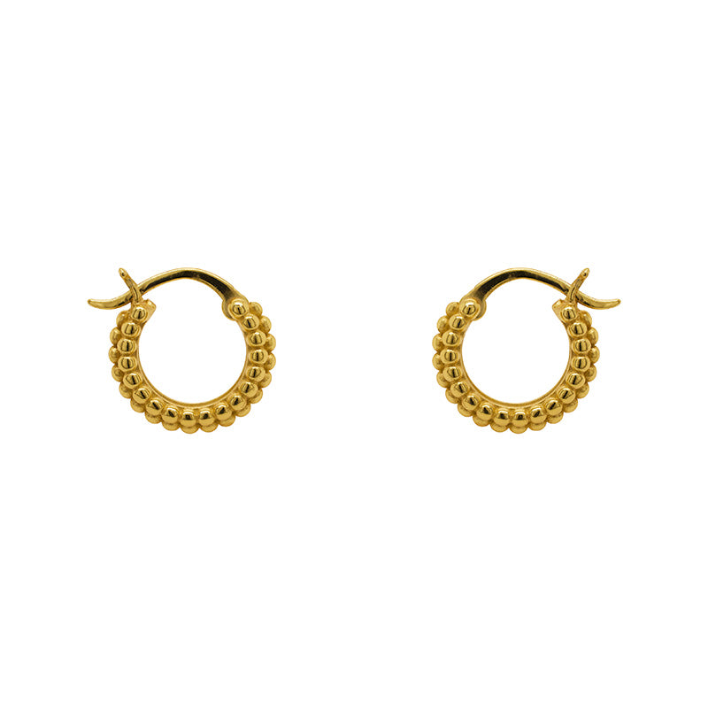 Small, beaded hoop earrings with a hinged post closure made of 14 kt yellow gold vermeil. Displayed side facing on a white background.