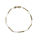 Overview of a gold filled bar and chain link style anklet on a white background.