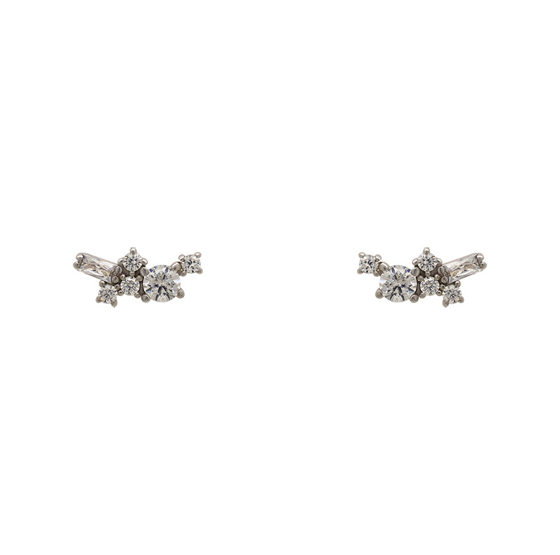 A pair of sterling silver cluster studs with 1 large, round crystal, 4 smaller round crystals and 1 baguette cut crystal on a white background.