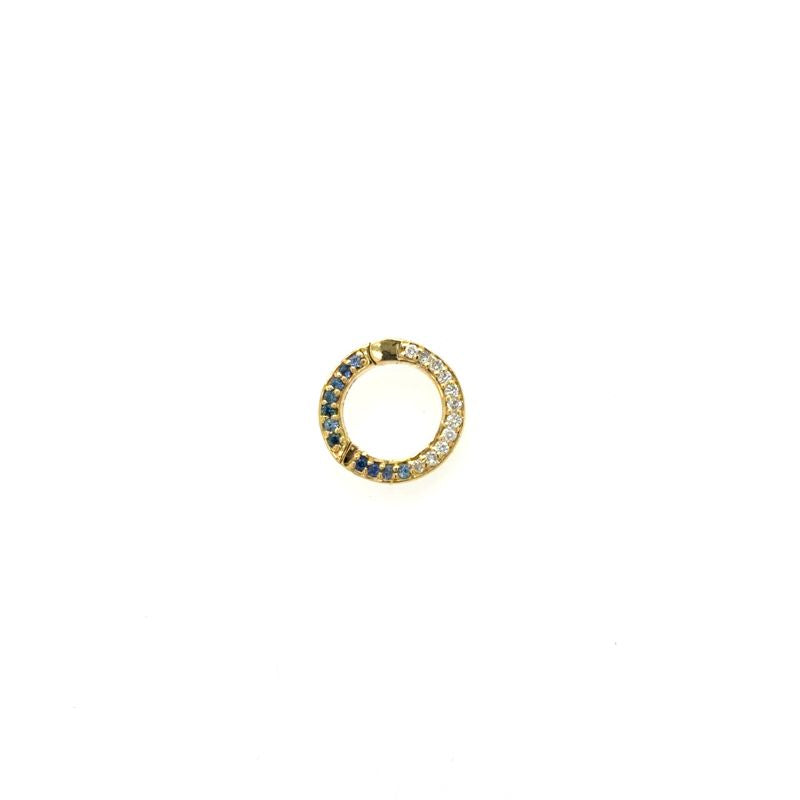 A front view of a yellow gold connector clip with blue sapphires and diamonds shown on a white background. 