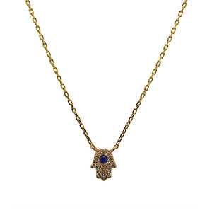 
                  
                    Load image into Gallery viewer, A 14 kt yellow gold hamsa style charm encrusted with diamonds and one blue sapphire, connected to a 14 kt yellow gold chain.
                  
                