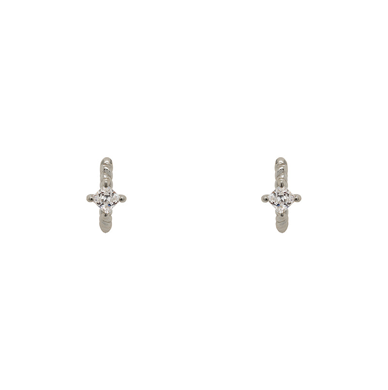 
                  
                    Load image into Gallery viewer, A pair of twist pattern style huggie earrings with princess cut crystals made of sterling silver. Displayed forward facing on a white background.
                  
                