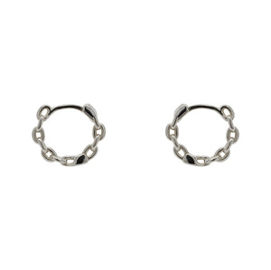 
                  
                    Load image into Gallery viewer, A pair of hinged huggie hoops with chain pattern cast in sterling silver. Displayed side facing on a marble background.
                  
                