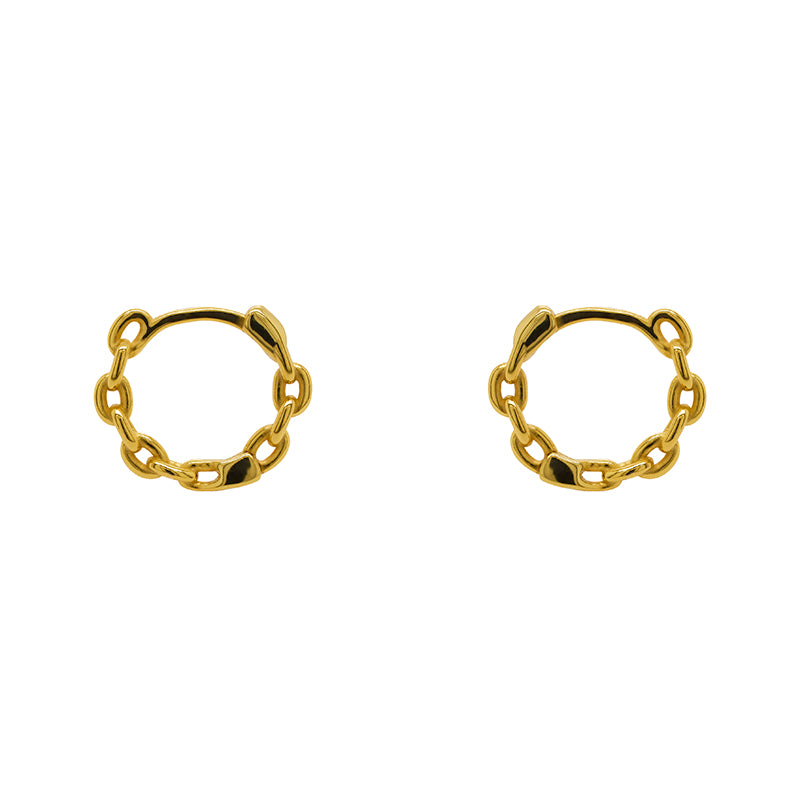 A pair of hinged huggie hoops with chain pattern cast in sterling silver with a 14kt yellow gold plating. Displayed side facing on a marble background.