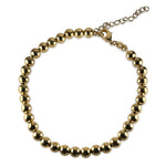 Overview of a gold filled bead style anklet on a white background.