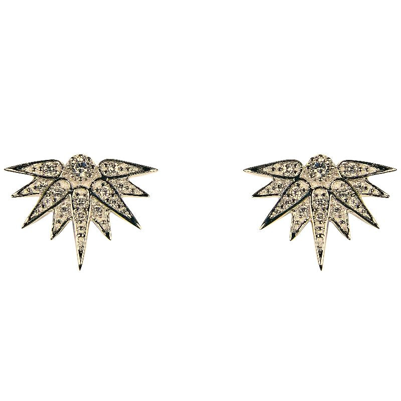 A yellow gold and crystal pair of studs shown on a white background.