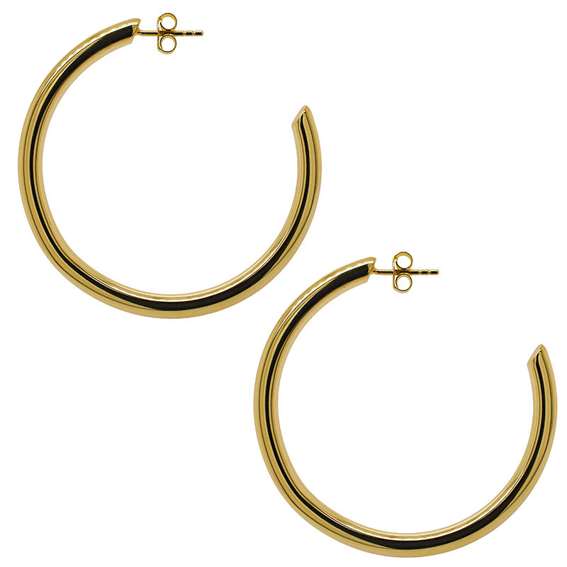 
                  
                    Load image into Gallery viewer, A pair of 14 kt yellow gold vermeil 3/4 hoop earrings on top of white tile.
                  
                
