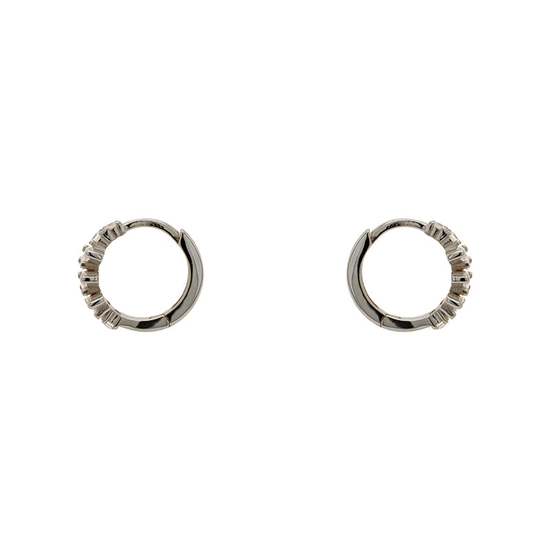 
                  
                    Load image into Gallery viewer, A pair of huggie style earrings made of sterling silver with tapered baguette crystals. Displayed side facing on a white background.
                  
                
