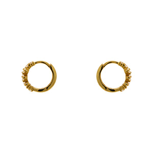 
                  
                    Load image into Gallery viewer, A pair of huggie style earrings made of 14kt yellow gold vermeil with tapered baguette crystals. Displayed side facing on a white background.
                  
                