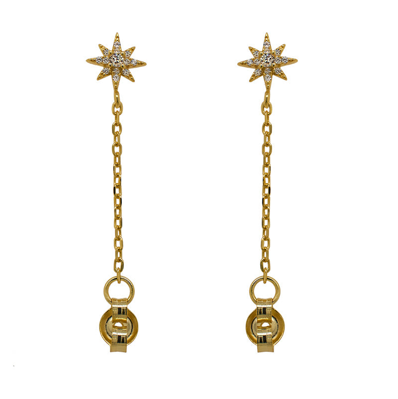 A pair of 14 kt yellow gold vermeil starburst studs with a chain connected to the earring backs on a white background.