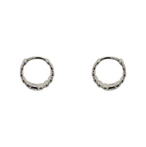 
                  
                    Load image into Gallery viewer, Pair of hinged huggie earrings with a flat organic texture. 4.6mm wide and made of sterling silver. Displayed side facing on a white background.
                  
                
