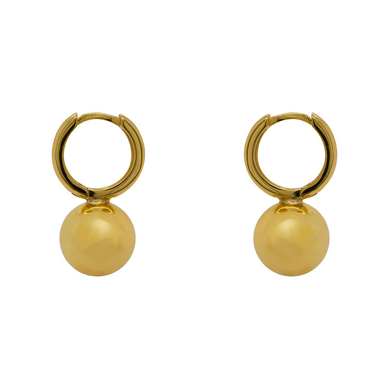 Huggie style earrings with a large ball accent on the bottom and made of 14 kt yellow gold vermeil.  Displayed side facing on a white background.