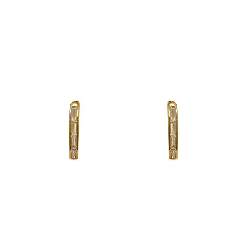 Geometric shaped hoop earrings made of 925 sterling silver with 14 kt yellow gold vermeil. Hoops have tiny baguette crystals set on one side. Displayed forward facing and on a white background.