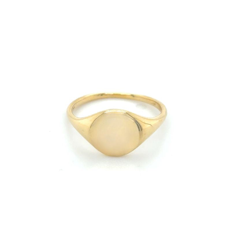 A front view of a yellow gold round signet ring shown on a white background.