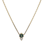 Set in a north-south setting, this blue-green round cut sapphire and diamond necklace is cast in 14 kt yellow gold.
