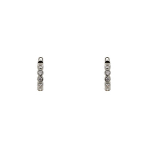 
                  
                    Load image into Gallery viewer, A pair of huggie style earrings with 2 mm bezel set crystals and a sterling silver setting. Displayed forward facing on a white background.
                  
                