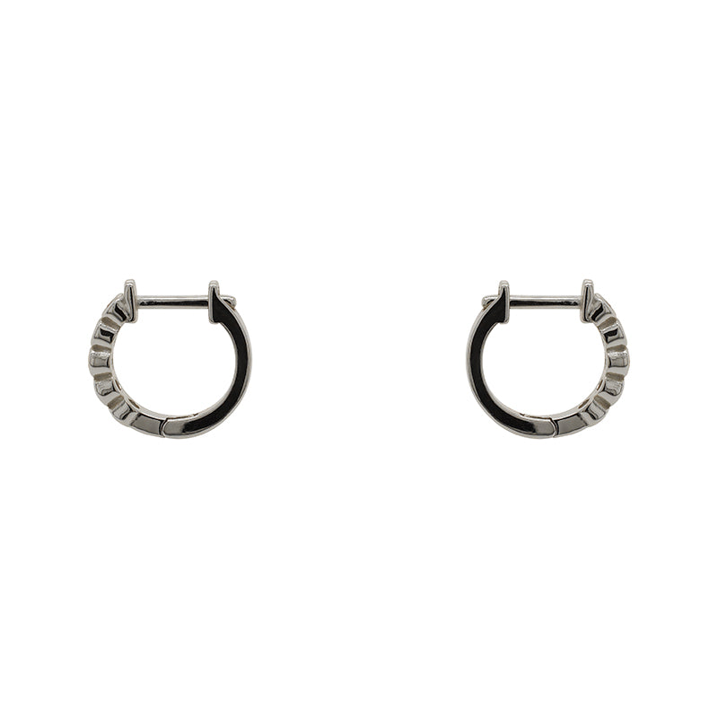 
                  
                    Load image into Gallery viewer, A pair of huggie style earrings with 2 mm bezel set crystals and a sterling silver setting. Displayed side facing on a white background.
                  
                