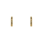 A pair of huggie style earrings with 2 mm bezel set crystals and a 14 kt yellow gold vermeil setting. Displayed forward facing on a white background.