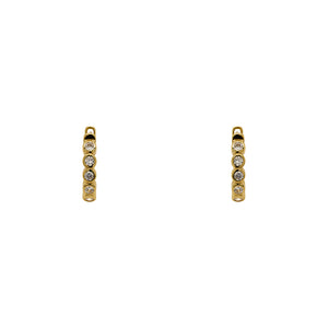 
                  
                    Load image into Gallery viewer, A pair of huggie style earrings with 2 mm bezel set crystals and a 14 kt yellow gold vermeil setting. Displayed forward facing on a white background.
                  
                