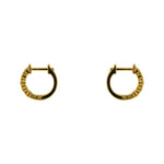 A pair of huggie style earrings with 2 mm bezel set crystals and a 14 kt yellow gold vermeil setting. Displayed side facing on a white background.