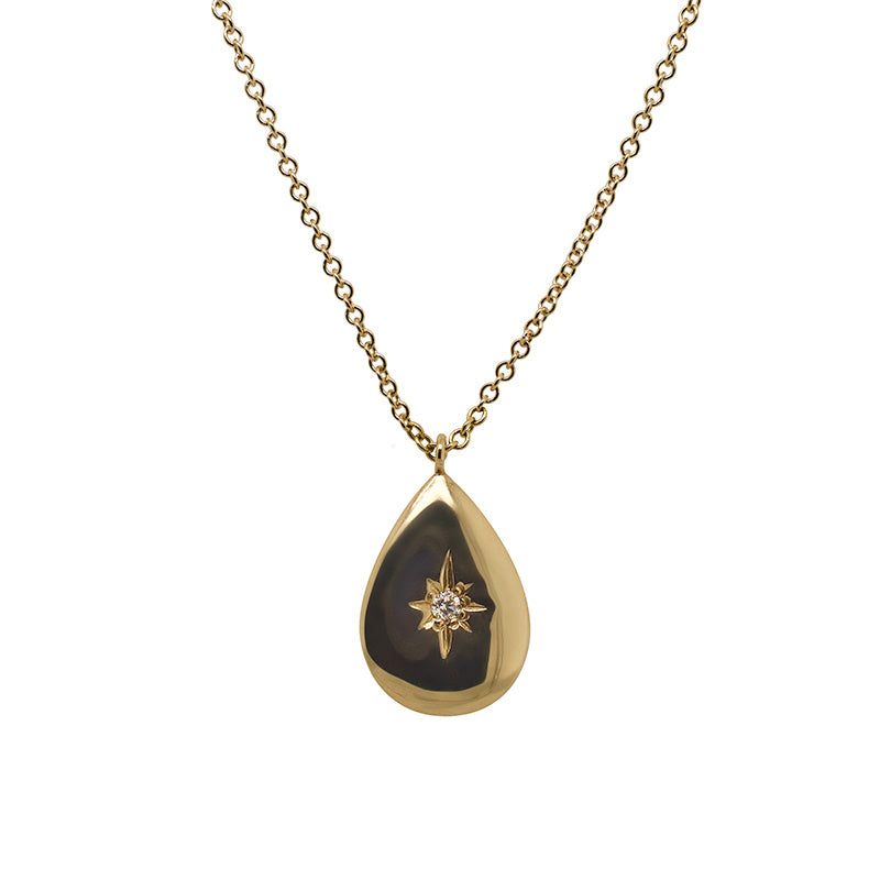 Front view of a tear drop shaped pendant necklace with a center diamond cast in 14 kt yellow gold.
