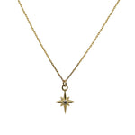 Petite size north star charm necklace with a tiny diamond in the center made of solid 14 kt yellow gold.