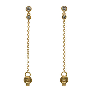 
                  
                    Load image into Gallery viewer, A pair of milgrain, bezel set round crystal studs with a smaller hanging bezel set crystal and chain connected to the earring back, and made of 14 kt yellow gold vermeil.
                  
                