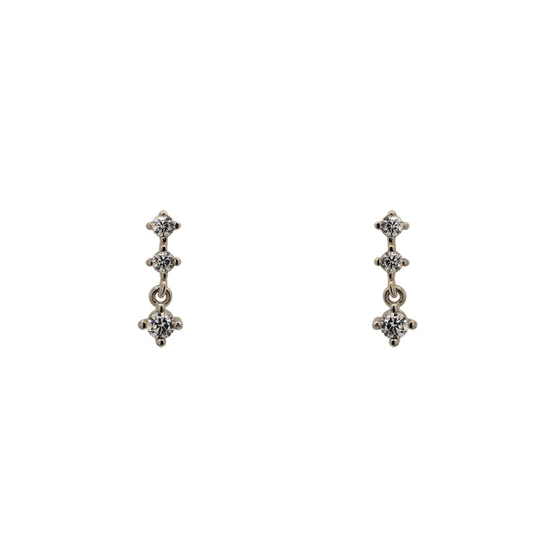 A pair of north south set double crystal studs with an additional stud dangling from the bottom, and made of 925 sterling silver.
