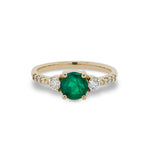Front view of round emerald ring with 2 medium and 6 small accent diamonds cast in 14 kt yellow gold.