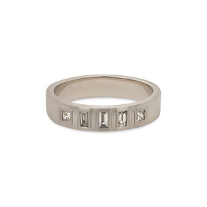 
                  
                    Load image into Gallery viewer, A wide, squared edge platinum band with 3 flush set baguette cut diamonds flanked by 2 flush set princess cut diamonds on a white background.
                  
                
