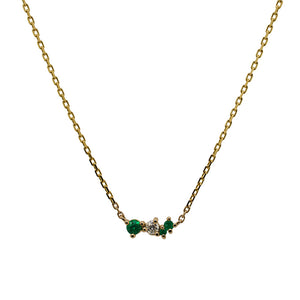 
                  
                    Load image into Gallery viewer, Front view of an asymmetrical cluster necklace set with three round emeralds and one round diamond. Set in 14 kt yellow gold
                  
                