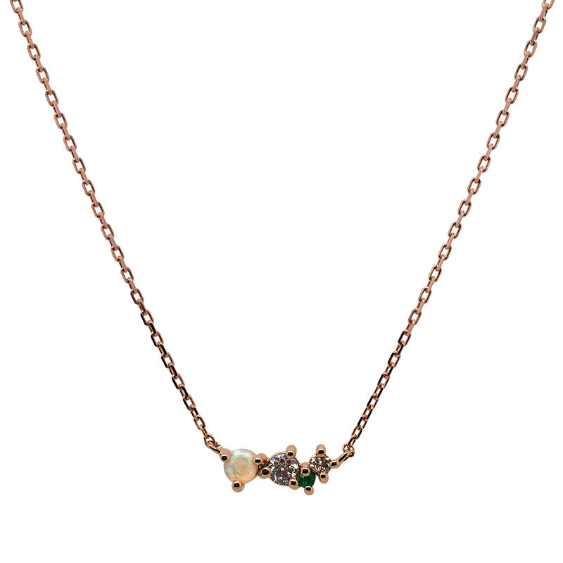
                  
                    Load image into Gallery viewer, Front view of an asymmetrical cluster necklace set with a cabachon opal, one round emerald and two round diamonds. Set in 14 kt rose gold.
                  
                
