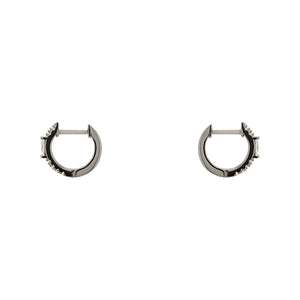 
                  
                    Load image into Gallery viewer, A pair of huggie style earrings with round and baguette crystals in a sterling silver setting. Displayed side facing on a white background.
                  
                